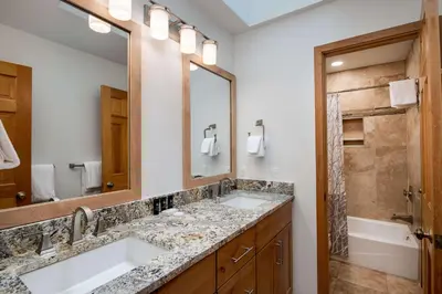 a bathroom with two sinks and a large mirror at Stonebridge Townhome: Remodeled, Quiet Frisco Location in Frisco