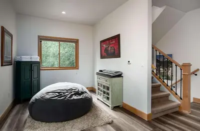 a room with a ottoman in the middle of a room at Stonebridge Townhome: Remodeled, Quiet Frisco Location in Frisco
