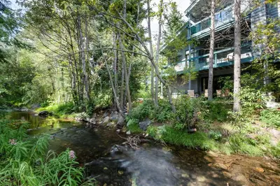 a river in front of a building next to a building at Stonebridge Townhome: Remodeled, Quiet Frisco Location in Frisco