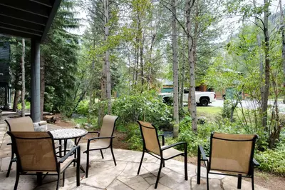 a patio with a table and chairs and trees at Stonebridge Townhome: Remodeled, Quiet Frisco Location in Frisco