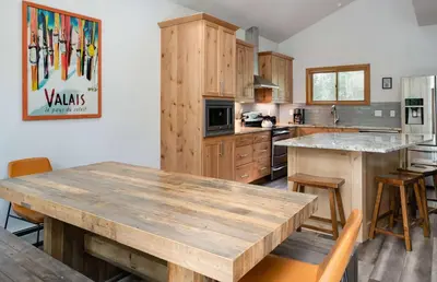 a kitchen with a large wooden table and chairs at Stonebridge Townhome: Remodeled, Quiet Frisco Location in Frisco