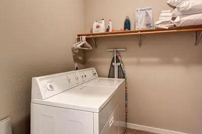 a washing machine in a laundry room with a shelf at Crossroads Snowshoe Townhome: Great Views, On Rec Path in Summit Medical Center Heliport