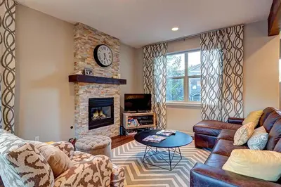 a living room with a couch and a fireplace at Crossroads Snowshoe Townhome: Great Views, On Rec Path in Summit Medical Center Heliport