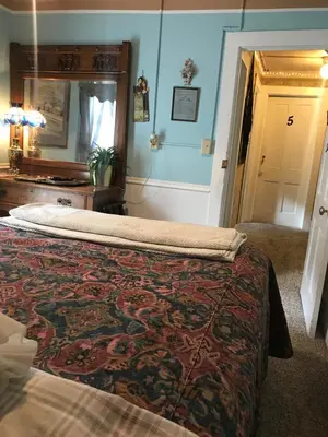 a bedroom with a bed with a rug on it at Historic Windsor in Silver Plume