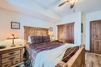 a bedroom with a bed and a dresser at Highland Greens Lodge 210 Colorado in Breckenridge