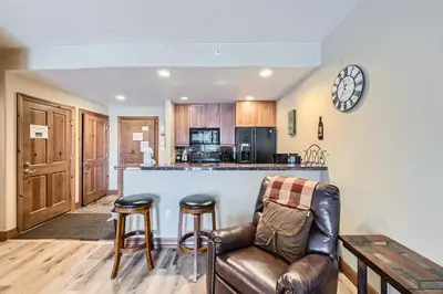 a living room with a couch and a kitchen at Highland Greens Lodge 210 Colorado in Breckenridge