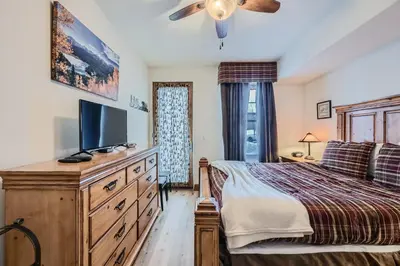 a bedroom with a bed and a tv on a dresser at Highland Greens Lodge 210 Colorado in Breckenridge