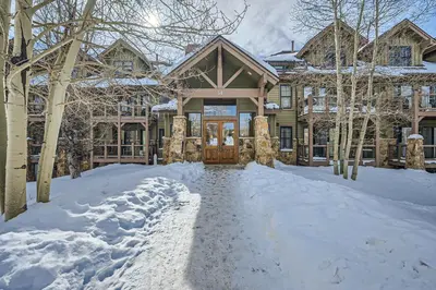 a house with a snow covered driveway in front of it at Highland Greens Lodge 210 Colorado in Breckenridge