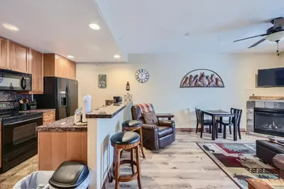 a kitchen and living room with a table and chairs at Highland Greens Lodge 210 Colorado in Breckenridge