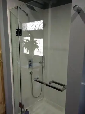 a bathroom with a shower with a glass door at Off Broadway B & B in Denver