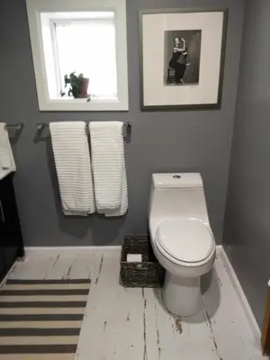 a bathroom with a white toilet and a window at Off Broadway B & B in Denver