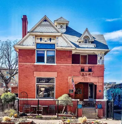 a large red brick house with a window at Off Broadway B & B in Denver