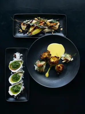 two black plates of food on a black table at Limelight Hotel Denver in Denver