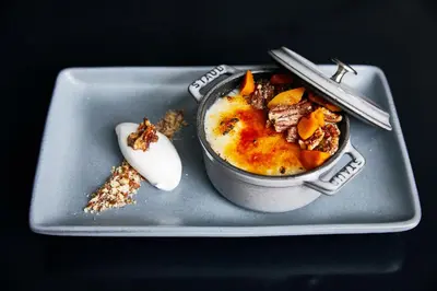 a bowl of food on a plate with a spoon at Limelight Hotel Denver in Denver