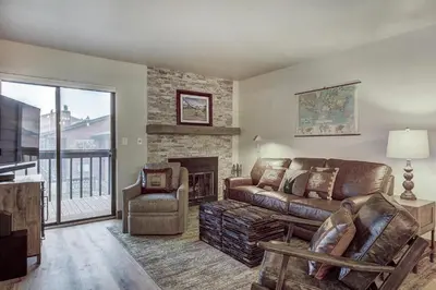 a living room with a couch and a fireplace at 241C Mountain Side Condo in Frisco