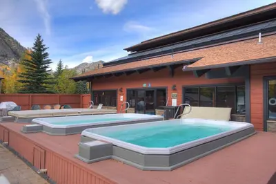 a swimming pool on a patio with a house at 241C Mountain Side Condo in Frisco