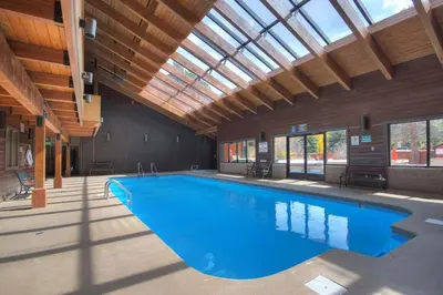 a large swimming pool in a building with a ceiling at 241C Mountain Side Condo in Frisco