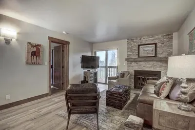 a living room with a couch and a fireplace at 241C Mountain Side Condo in Frisco