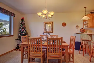 a dining room with a table and a christmas tree at 127 Lookout Ridge Townhouse in Dillon