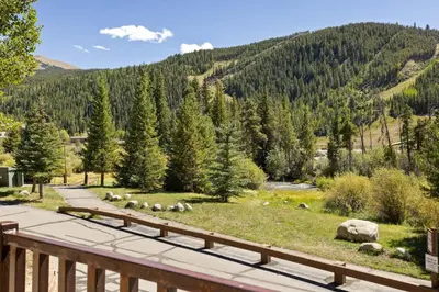 a view from a deck of a mountain with a river at 5949 Hidden River Lodge Condo in Keystone