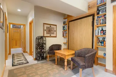 a tasting room with two chairs and a wooden table at 5949 Hidden River Lodge Condo in Keystone