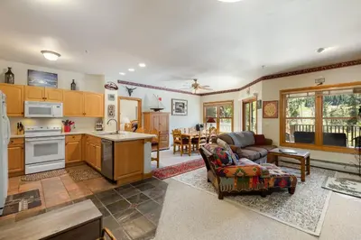 a kitchen and living room with a couch and a table at 5949 Hidden River Lodge Condo in Keystone