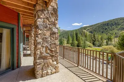 a balcony of a cabin with a view of the mountains at 5949 Hidden River Lodge Condo in Keystone