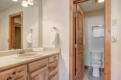 a bathroom with a sink and a toilet and a mirror at Ffd7 Frostfire Condo in Keystone