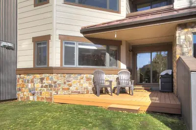 two chairs sitting on a deck in front of a house at Ffd7 Frostfire Condo in Keystone