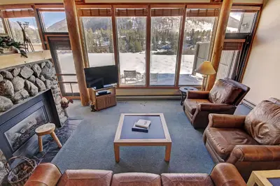 a living room with couches and a fireplace and a tv at 2035 Homestead Condo in Keystone