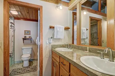 a bathroom with two sinks and a toilet at 2035 Homestead Condo in Keystone