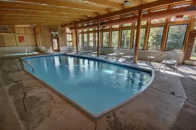 a large swimming pool in a building with windows at 2035 Homestead Condo in Keystone