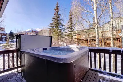 a hot tub on a balcony with snow on it at 172 Sauterne Sanctuary Townhouse in Silverthorne