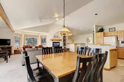 a kitchen and dining room with a wooden table and chairs at 172 Sauterne Sanctuary Townhouse in Silverthorne