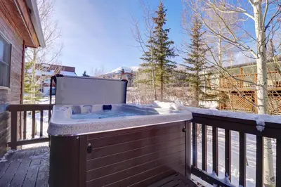 a hot tub on the deck of a house at 172 Sauterne Sanctuary Townhouse in Silverthorne