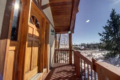 a porch of a house with a wooden door at 172 Sauterne Sanctuary Townhouse in Silverthorne
