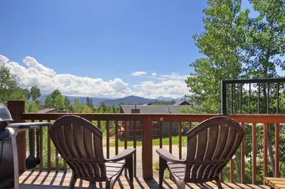 two chairs sitting on a deck with a table at 172 Sauterne Sanctuary Townhouse in Silverthorne