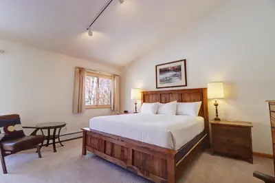 a bedroom with a bed and a desk and a chair at 172 Sauterne Sanctuary Townhouse in Silverthorne