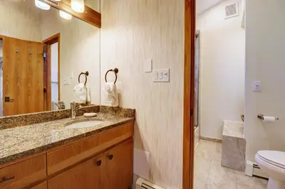 a bathroom with a sink and a toilet and a mirror at Cc301 Cross Creek Condo in Frisco