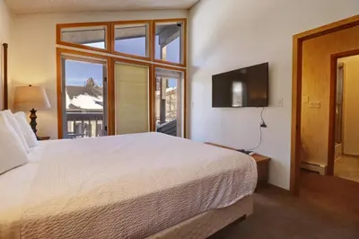 a bedroom with a large bed and a large window at Cc301 Cross Creek Condo in Frisco