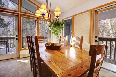 a dining room with a wooden table and chairs at Cc301 Cross Creek Condo in Frisco