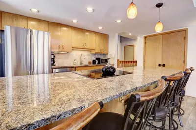 a kitchen with a large counter with bar stools at Cc301 Cross Creek Condo in Frisco