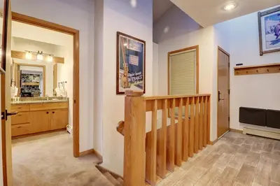aoyer with a stairway leading to a kitchen with a sink at Cc301 Cross Creek Condo in Frisco
