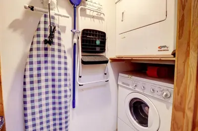 a small kitchen with a washer and dryer at Cc301 Cross Creek Condo in Frisco