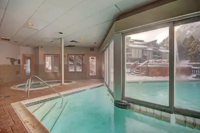 a large indoor swimming pool with a large window at Cc301 Cross Creek Condo in Frisco