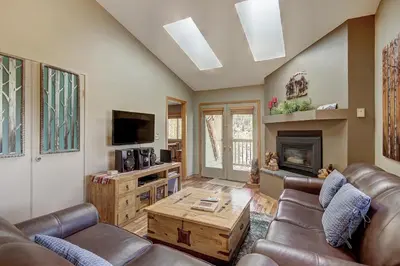 a living room with leather couches and a fireplace at 315 Woodbridge Condo in Frisco