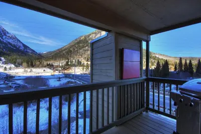 a balcony with a view of a snow covered mountain at 315 Woodbridge Condo in Frisco