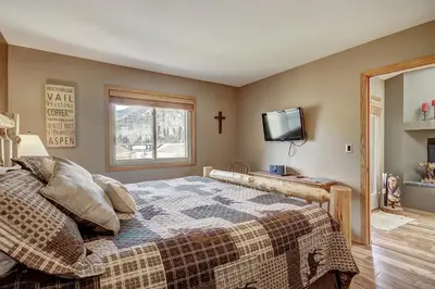 a bedroom with a bed with a cross on the wall at 315 Woodbridge Condo in Frisco
