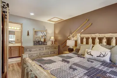 a bedroom with a bed and a dresser and a mirror at 315 Woodbridge Condo in Frisco