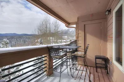 a balcony with a table and chairs and a view at 522 Watch Hill Condo in Silverthorne